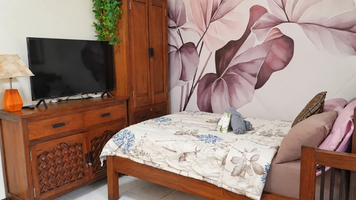 The floral bedroom and television